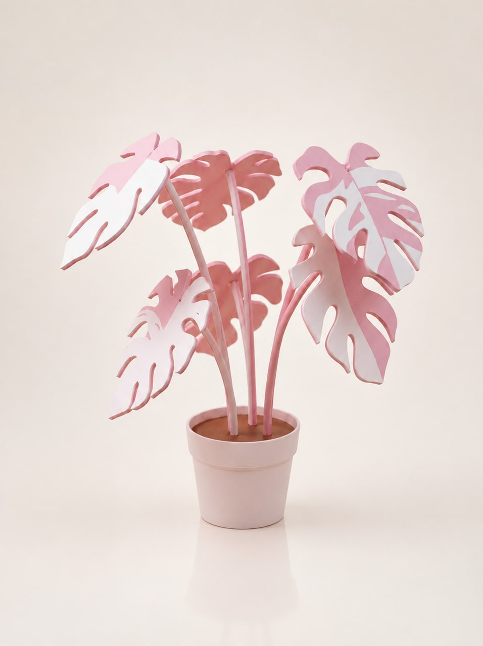 The Profera sculpture on a table, six pink and white leaves fanned above the planter